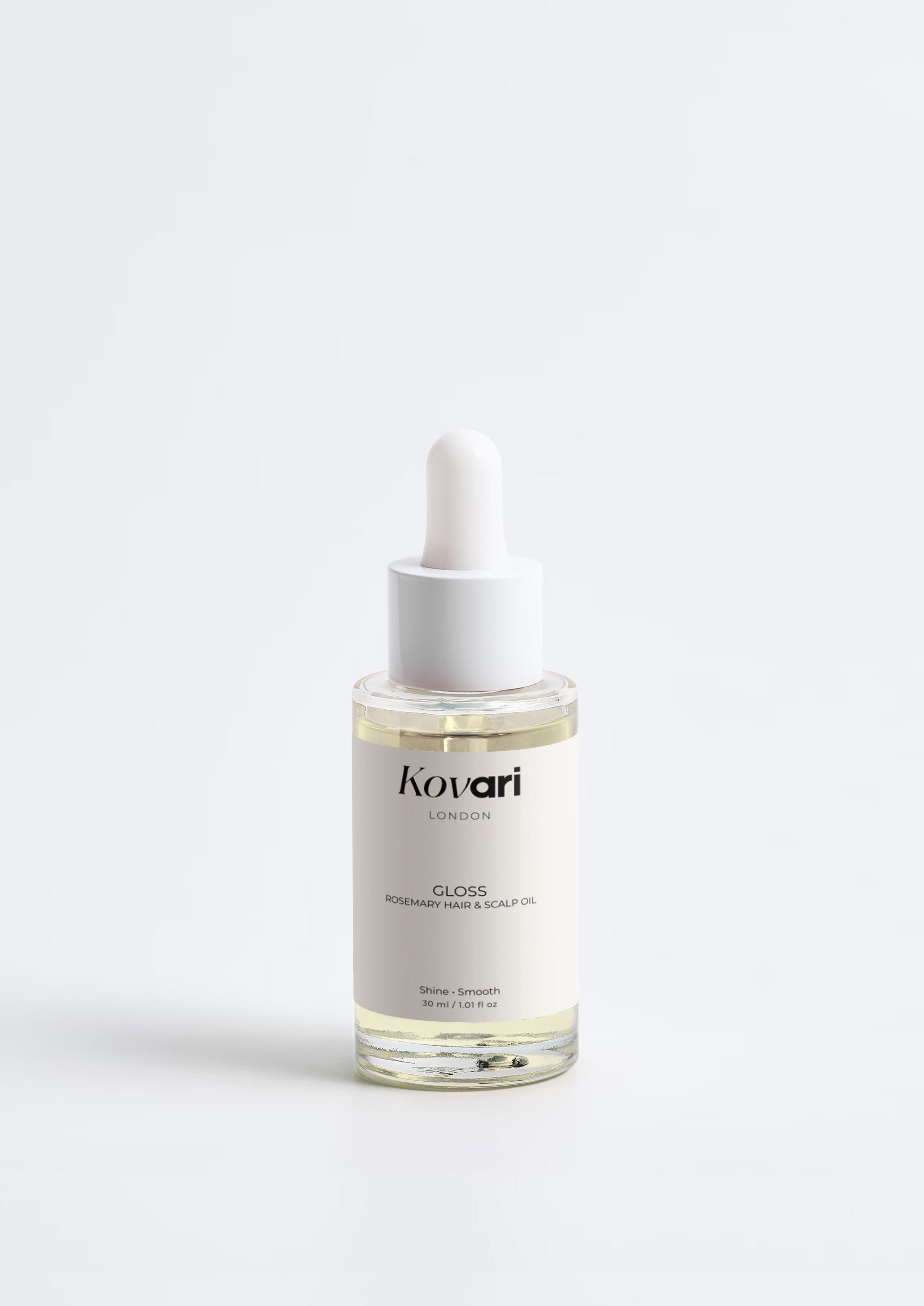 Bottle of KOVARI Gloss Hair Oil on a white background